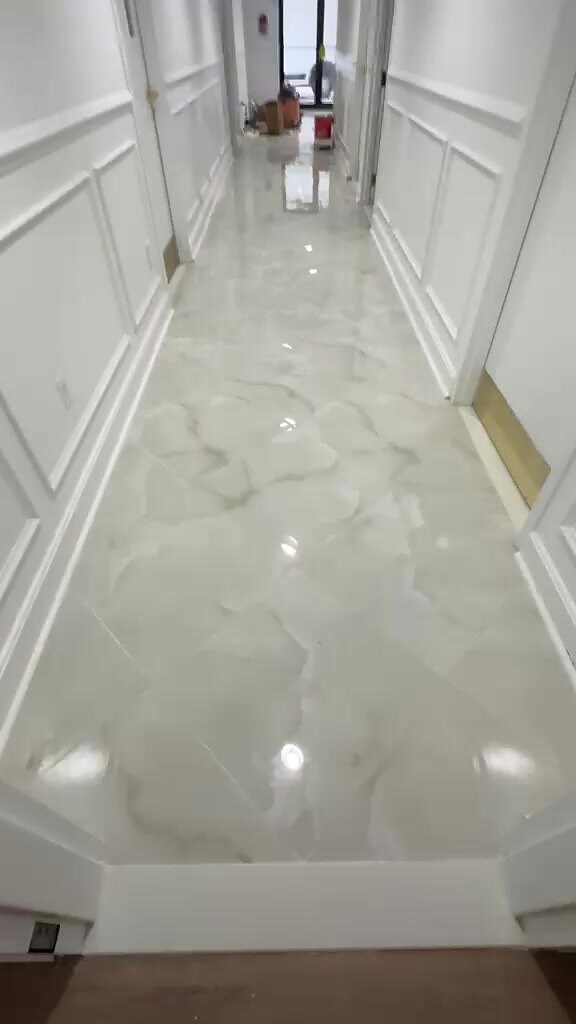 Polished large-format porcelain floor running down a hallway