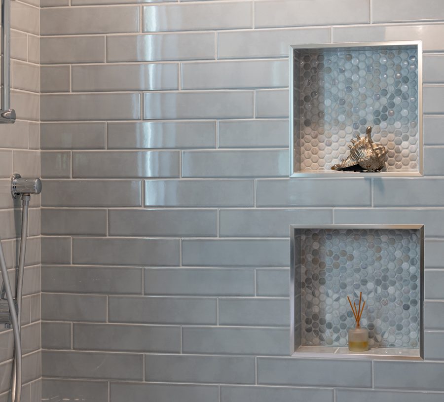 Tiled shower wall with recessed niches
